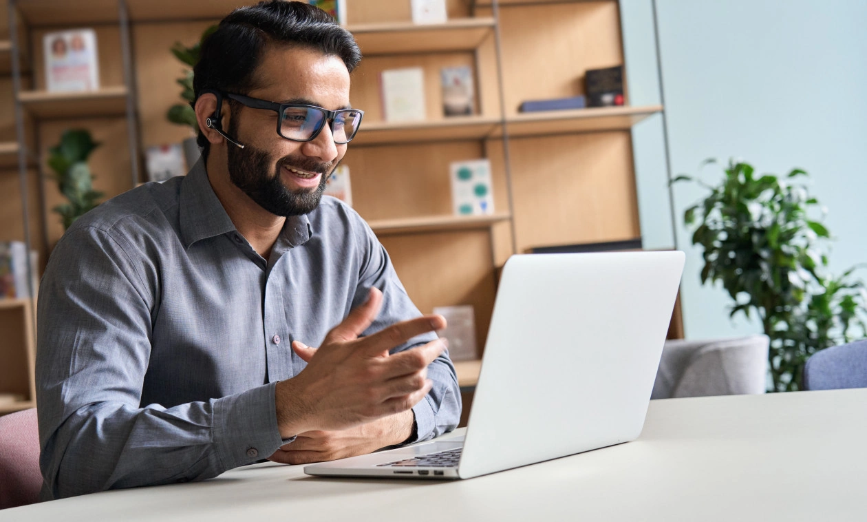 Happy indian business man remote teacher giving distance learning class.