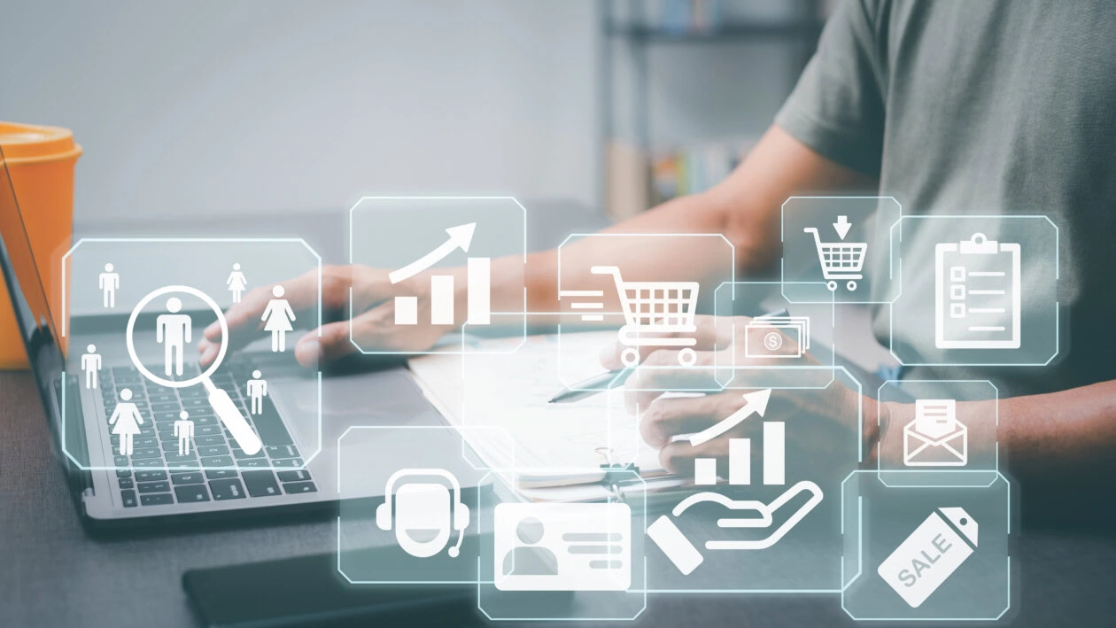 Entrepreneurs work on laptops that feature customer analytics icons, marketing plans and marketing strategies, customer behavior and purchase analysis, and customer research in various aspects.